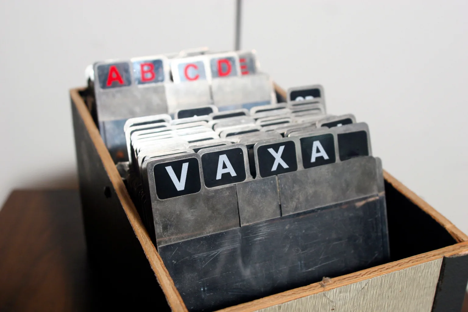 Image depicting a filing cabinet, with the word Vaxa spelled letter-by-letter on the labels of the files.