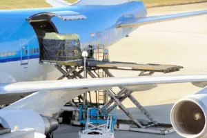 Freighter airplane being loaded with cargo.