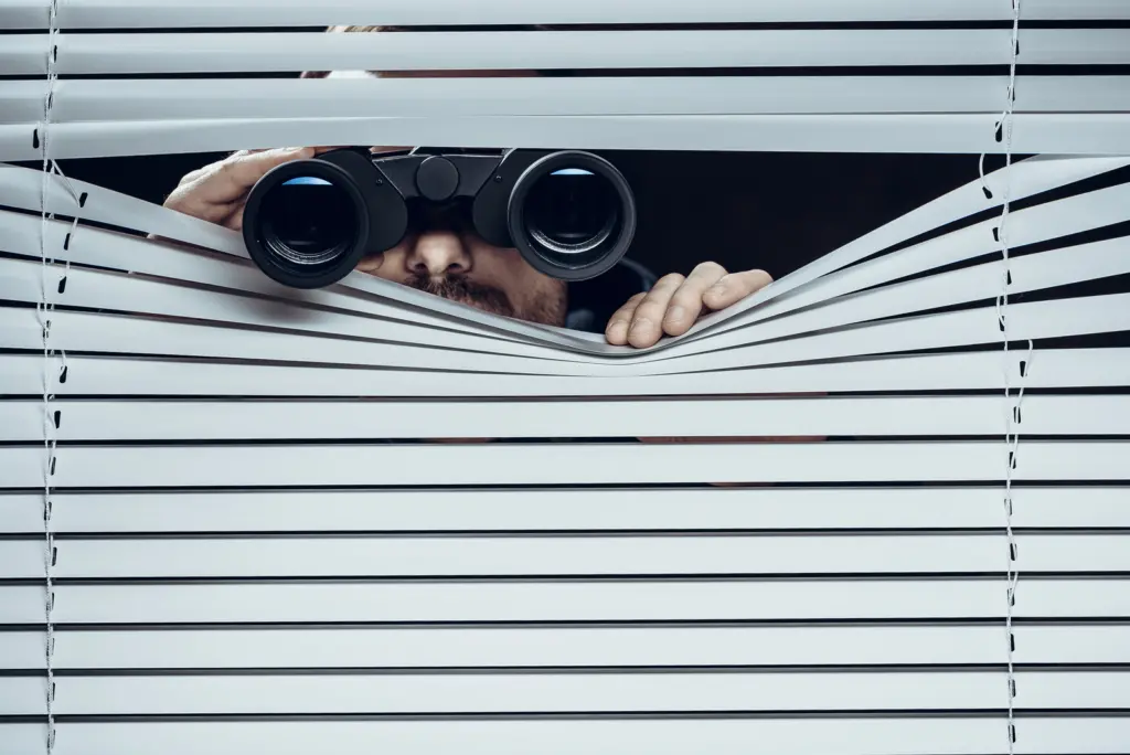 Spy at work. Man with binoculars.